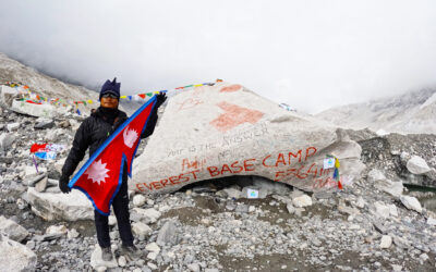 Mr. Nabin Pun, at the Everest Base Camp with the national flag using vivid language.